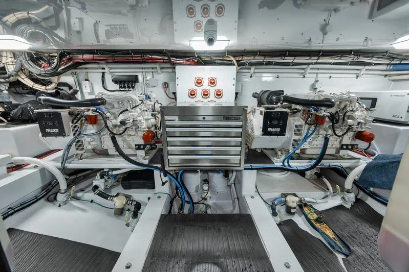 Knot Now Yacht Photos Pics Engine room of a 1997 Miller Marine Custom Carolina boat, featuring dual engines and organized wiring.