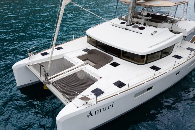  Yacht Photos Pics Lagoon 52 F catamaran, 2015 model, named Amuri, sailing on clear blue waters.