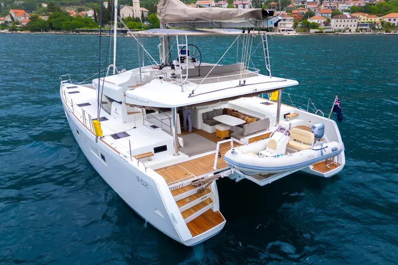  Yacht Photos Pics 2015 Lagoon 52 F catamaran on water, featuring spacious deck and modern design.