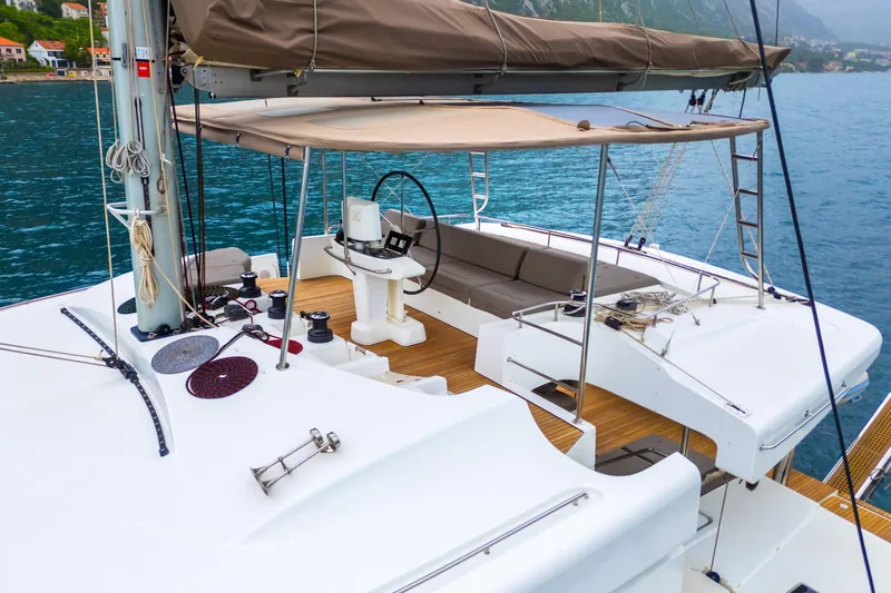  Yacht Photos Pics 2015 Lagoon 52 F yacht deck with helm, seating, and ocean view.
