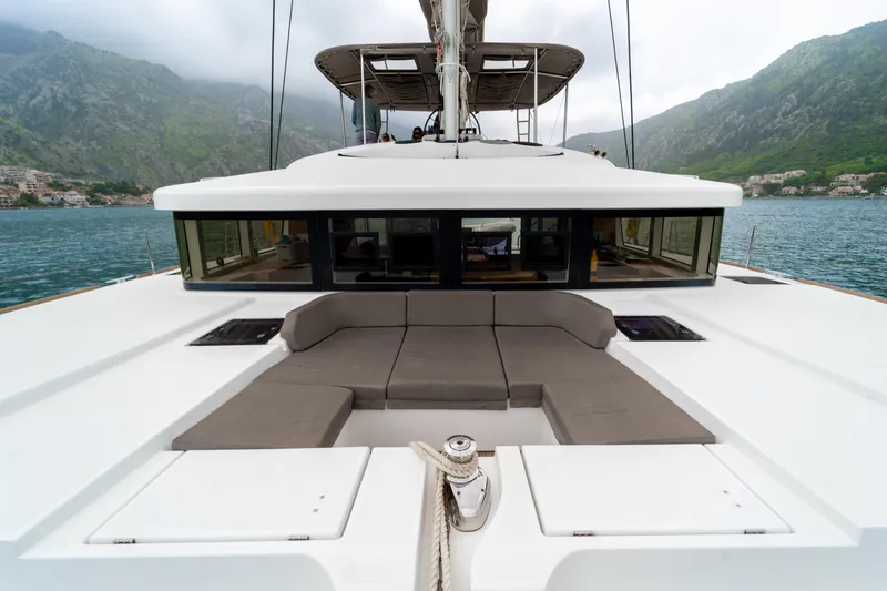  Yacht Photos Pics Luxurious 2015 Lagoon 52 F catamaran with spacious deck and scenic mountain backdrop.