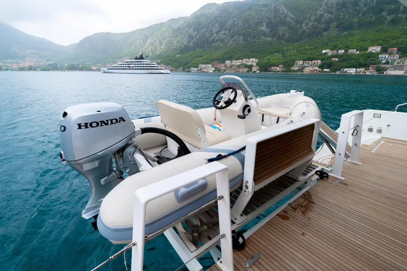  Yacht Photos Pics A 2015 Lagoon 52 F yacht with a Honda outboard motor in a scenic coastal setting.