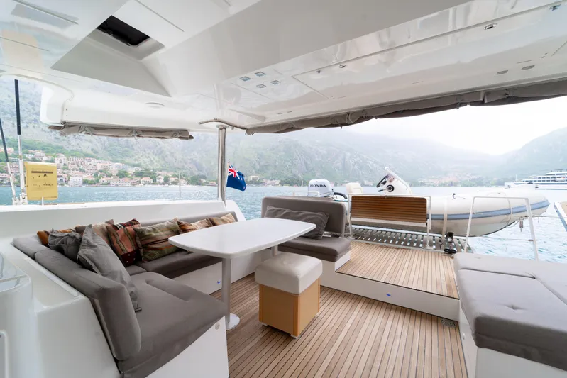  Yacht Photos Pics Luxurious 2015 Lagoon 52 F yacht deck with comfortable seating and scenic water view.