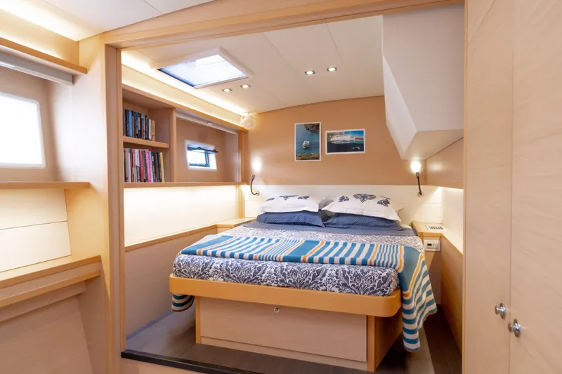  Yacht Photos Pics Luxurious cabin interior of 2015 Lagoon 52 F yacht with cozy bed and modern decor.