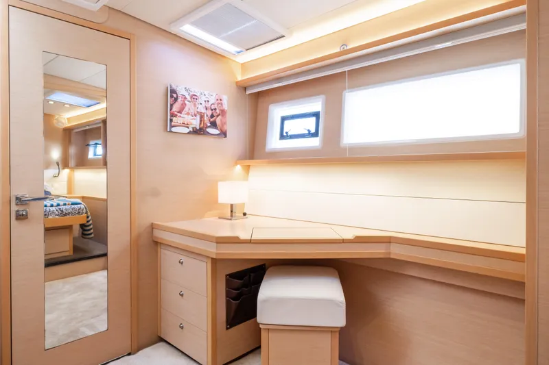  Yacht Photos Pics Luxurious interior of 2015 Lagoon 52 F yacht with desk, mirror, and modern decor.