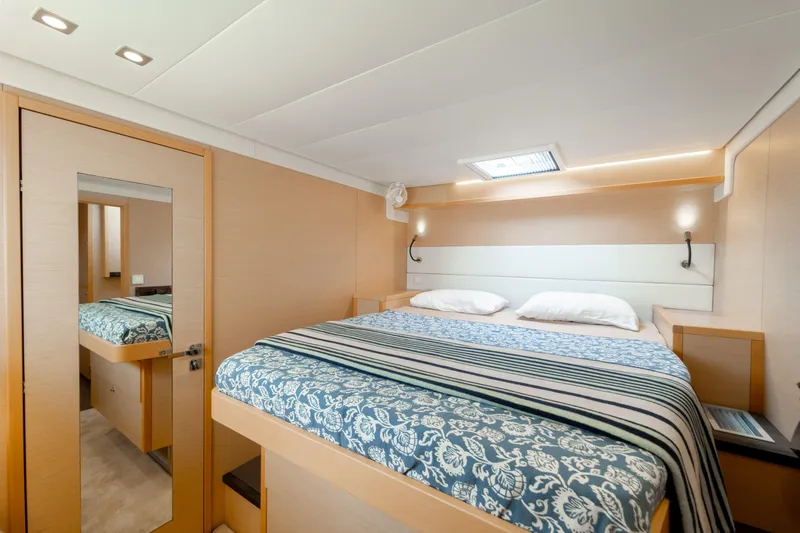  Yacht Photos Pics Luxurious cabin interior of 2015 Lagoon 52 F yacht with elegant bedding and modern lighting.