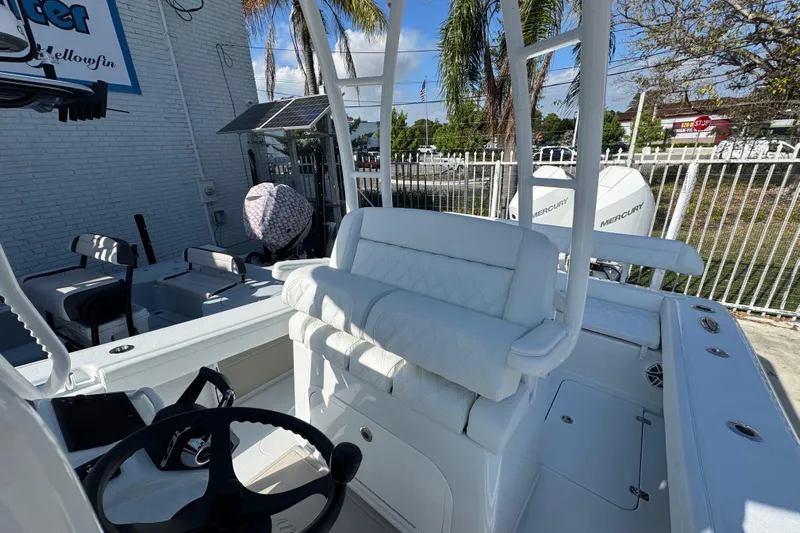  Yacht Photos Pics 2026 Yellowfin 26 Hybrid boat interior with white seating and steering wheel.