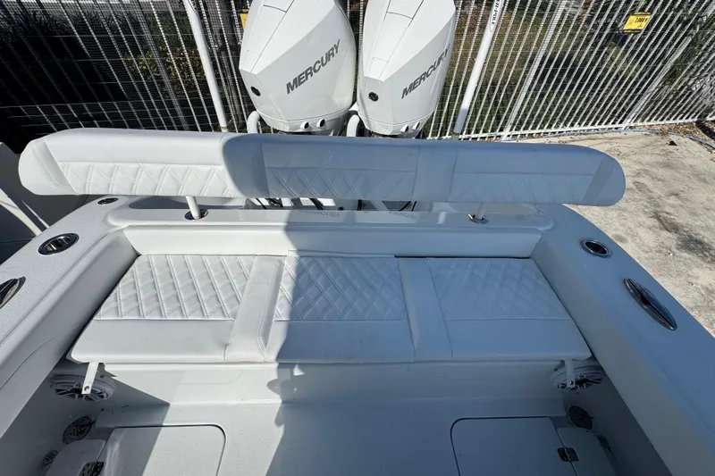  Yacht Photos Pics 2026 Yellowfin 26 Hybrid boat interior with Mercury engines, featuring white cushioned seating.