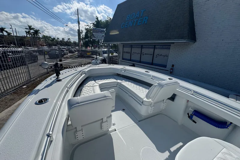  Yacht Photos Pics 2026 Yellowfin 26 Hybrid boat at a dealership, featuring spacious seating and modern design.