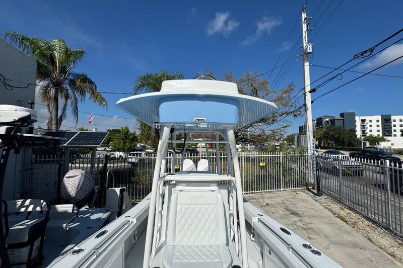  Yacht Photos Pics 2026 Yellowfin 26 Hybrid boat with T-top, parked outdoors under clear blue sky.