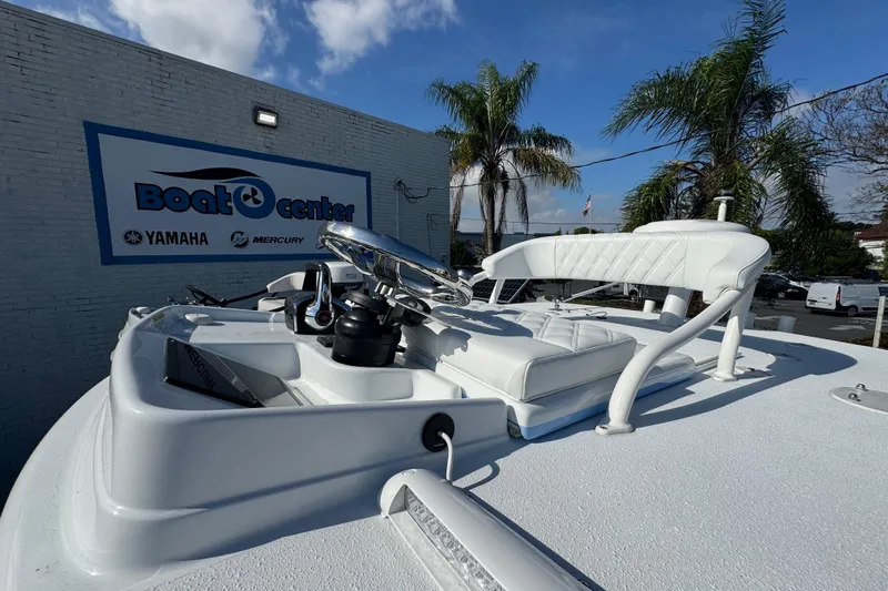  Yacht Photos Pics 2026 Yellowfin 26 Hybrid boat at dealership with palm trees and blue sky.