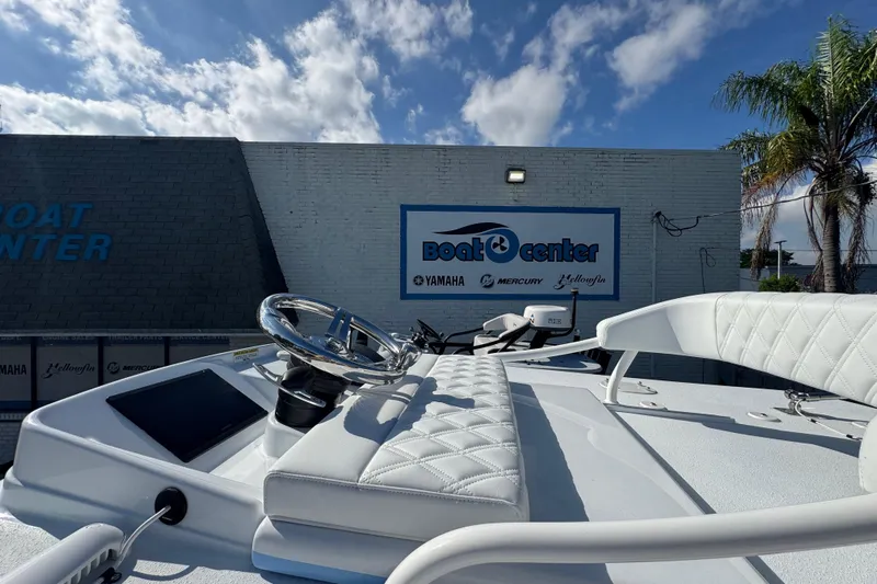  Yacht Photos Pics 2026 Yellowfin 26 Hybrid boat at dealership with clear sky background.