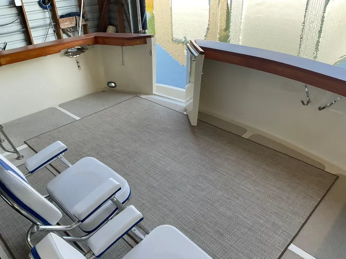  Yacht Photos Pics 1991 Nordic Pilothouse boat interior with seating and open deck view.