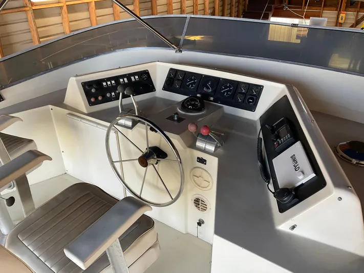  Yacht Photos Pics 1991 Nordic Pilothouse boat helm with steering wheel, control panel, and communication equipment.