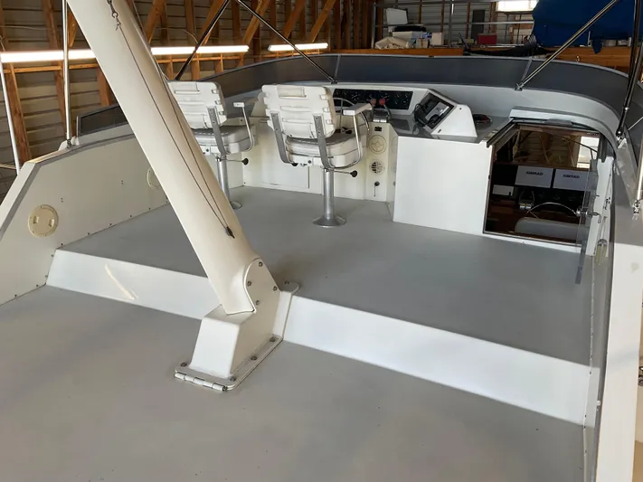  Yacht Photos Pics 1991 Nordic Pilothouse boat interior with helm and seating in a wooden boathouse.