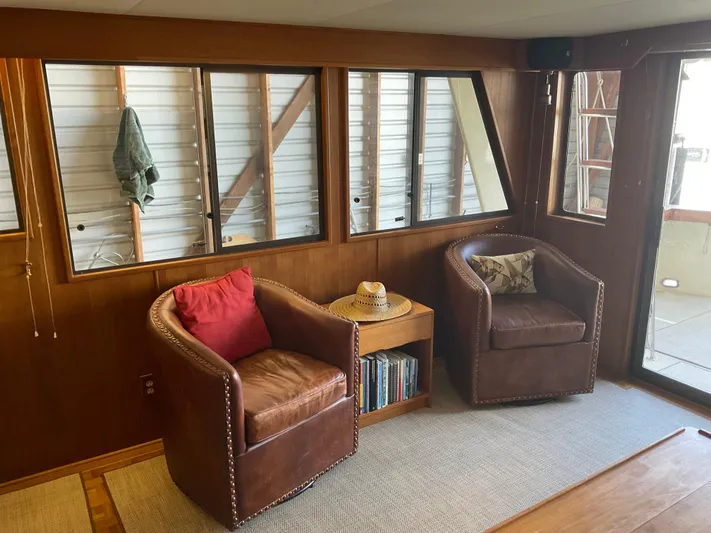  Yacht Photos Pics Cozy 1991 Nordic Pilothouse interior with leather chairs, wooden accents, and natural light.