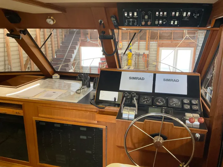  Yacht Photos Pics 1991 Nordic Pilothouse interior with steering wheel, navigation equipment, and control panels.