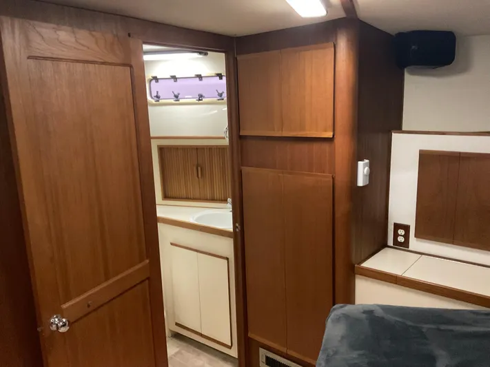  Yacht Photos Pics Interior of a 1991 Nordic Pilothouse boat featuring wood paneling and a compact bathroom.