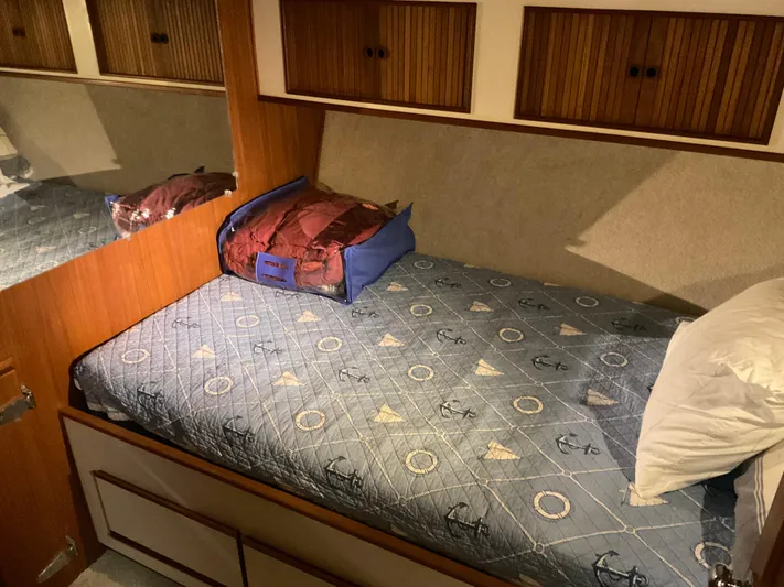  Yacht Photos Pics Cozy cabin bed in 1991 Nordic Pilothouse boat with nautical-themed bedding.