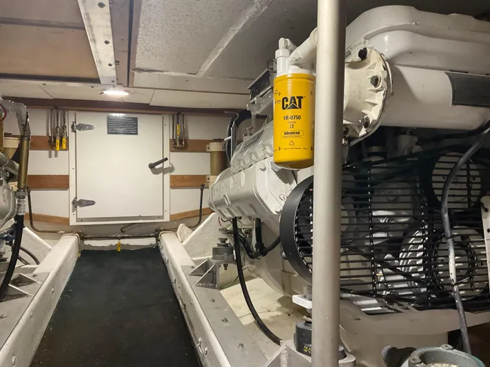  Yacht Photos Pics Engine room of a 1991 Nordic Pilothouse boat, featuring CAT machinery and equipment.
