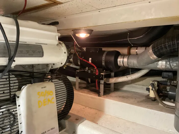  Yacht Photos Pics Engine room of a 1991 Nordic Pilothouse boat, featuring mechanical components and wiring.