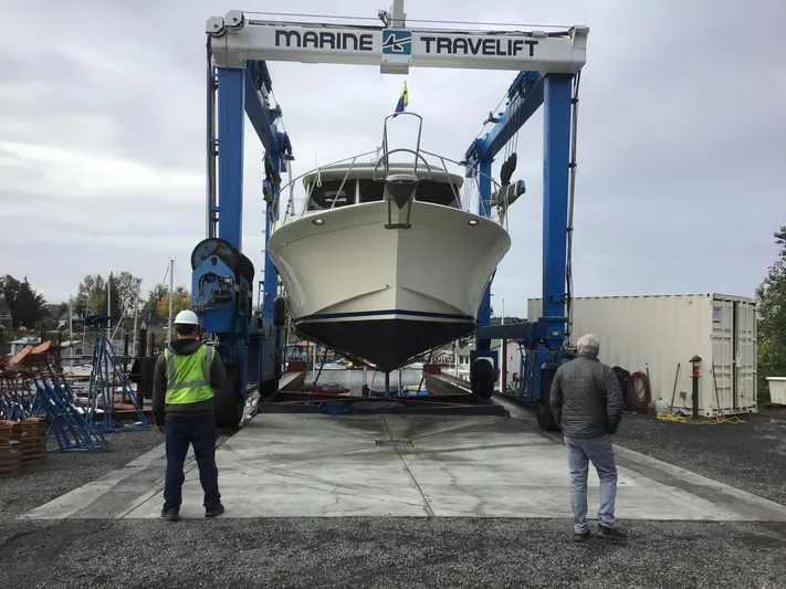  Yacht Photos Pics Nordic Pilothouse 1991 boat lifted by Marine Travelift at a shipyard.