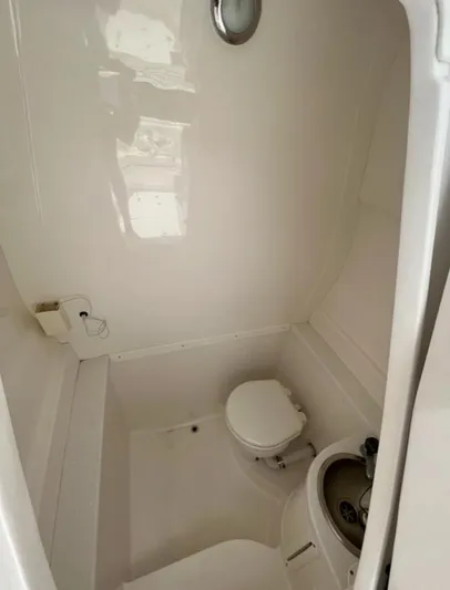 Gin Fizz Yacht Photos Pics Compact bathroom in a 2012 Intrepid 327 boat, featuring a toilet and sink.