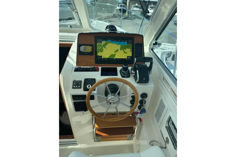 Yacht Photos Pics 2024 Back Cove 34O helm with navigation display and wooden steering wheel.