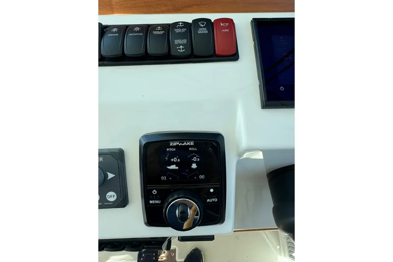  Yacht Photos Pics 2024 Back Cove 34O helm controls with Zipwake trim system and switches.