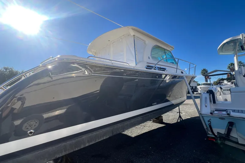  Yacht Photos Pics 2024 Back Cove 34O boat under bright sun, docked with clear blue sky.