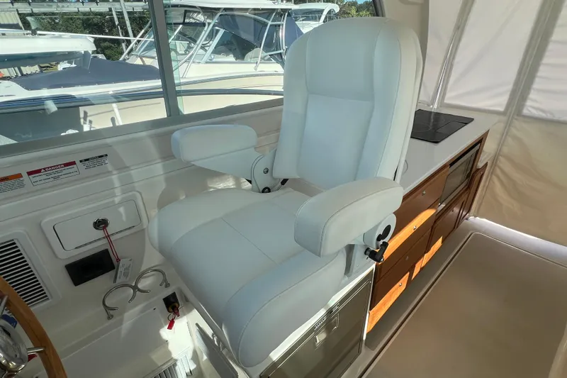  Yacht Photos Pics Captain's chair in 2024 Back Cove 34O yacht cockpit, featuring sleek design and modern amenities.