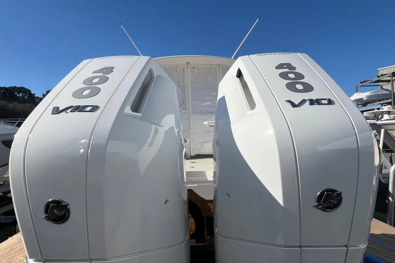  Yacht Photos Pics 2024 Back Cove 34O with dual Mercury 400 V10 outboard engines, docked under clear sky.