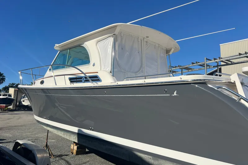  Yacht Photos Pics 2024 Back Cove 34O boat with sleek gray hull, docked under clear blue sky.