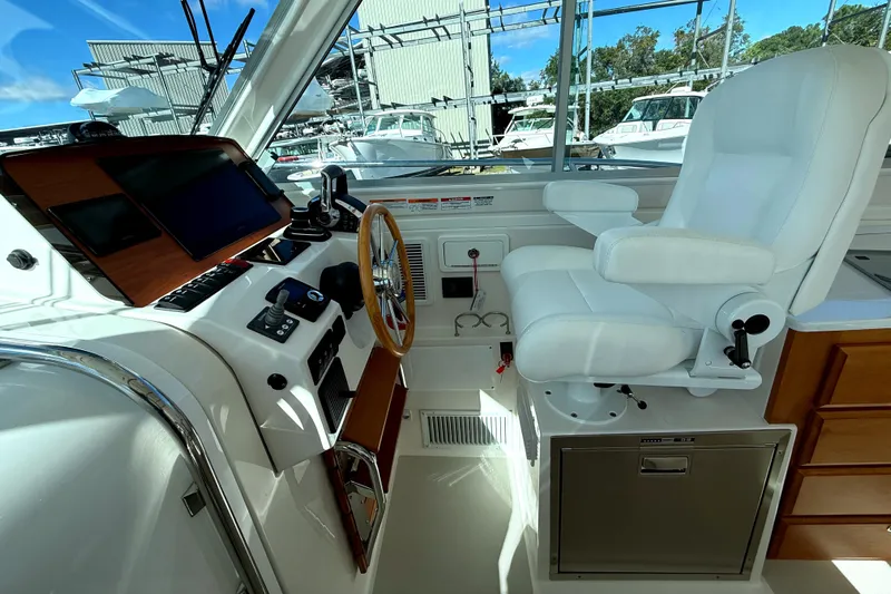  Yacht Photos Pics 2024 Back Cove 34O helm with white captain's chair and modern controls.