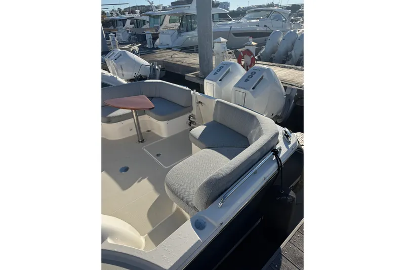  Yacht Photos Pics 2024 Back Cove 34O boat with seating area and outboard engines at a marina.