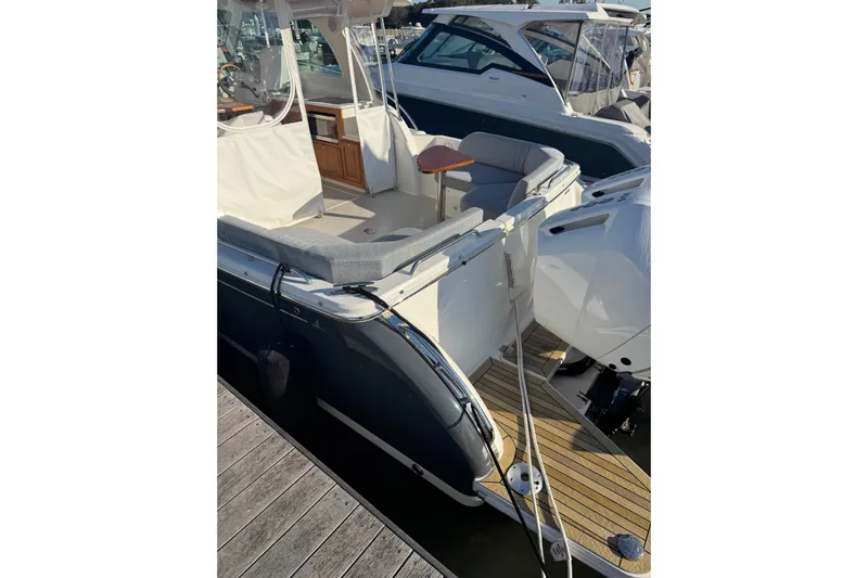  Yacht Photos Pics 2024 Back Cove 34O boat with spacious deck and seating area at a marina.