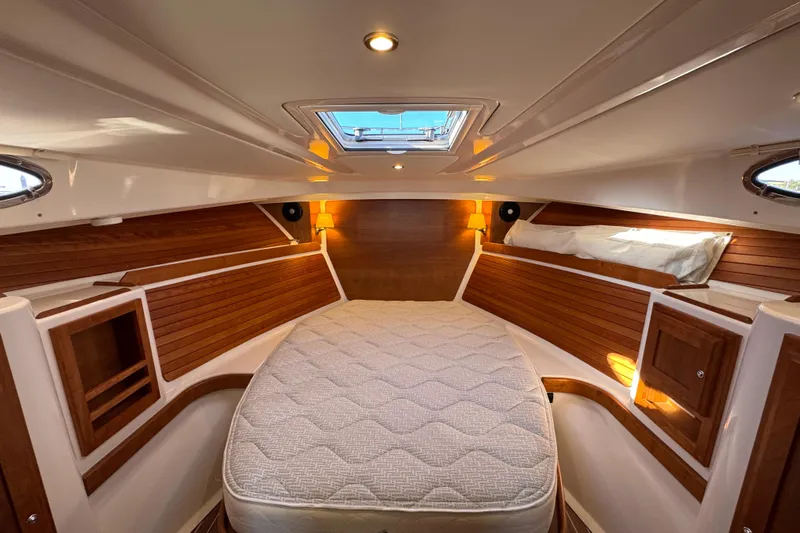  Yacht Photos Pics 2024 Back Cove 34O cabin interior with wood accents and cozy lighting.