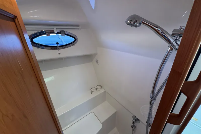  Yacht Photos Pics 2024 Back Cove 34O yacht bathroom with shower and porthole window.
