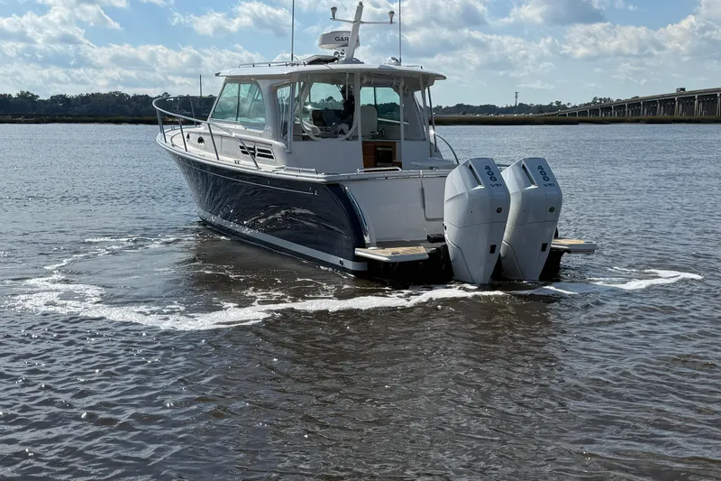  Yacht Photos Pics 2024 Back Cove 34O boat with dual outboard engines on calm water.