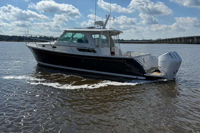  Yacht Photos Pics 2024 Back Cove 34O boat on water under a partly cloudy sky.