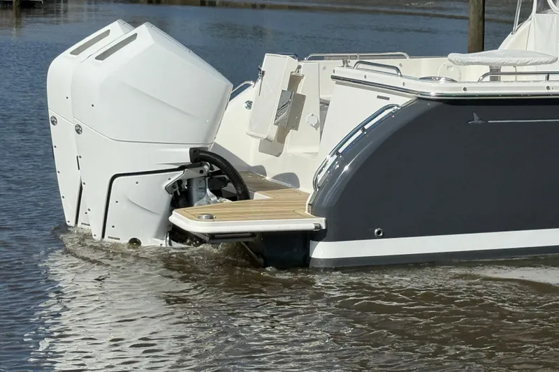  Yacht Photos Pics 2024 Back Cove 34O boat with dual outboard engines on water.