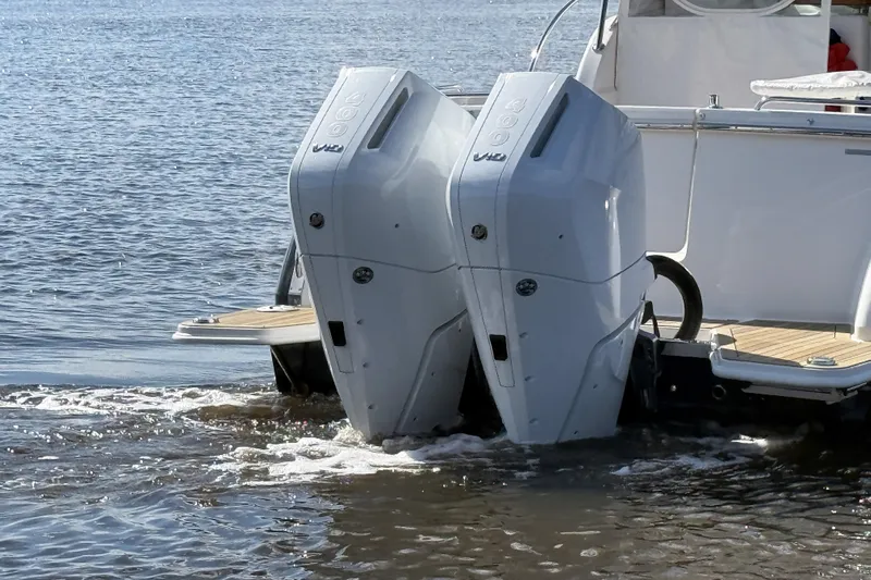  Yacht Photos Pics 2024 Back Cove 34O boat with dual outboard engines on water.