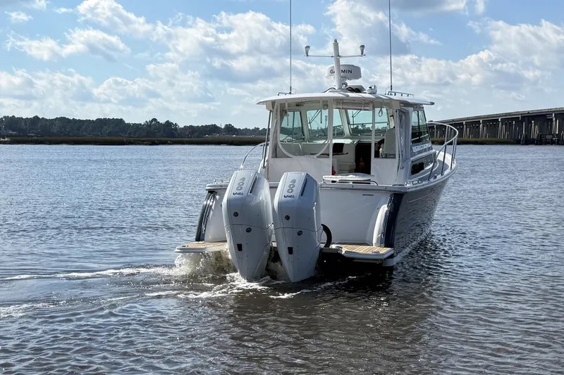  Yacht Photos Pics 2024 Back Cove 34O boat with dual outboard engines on a sunny day.