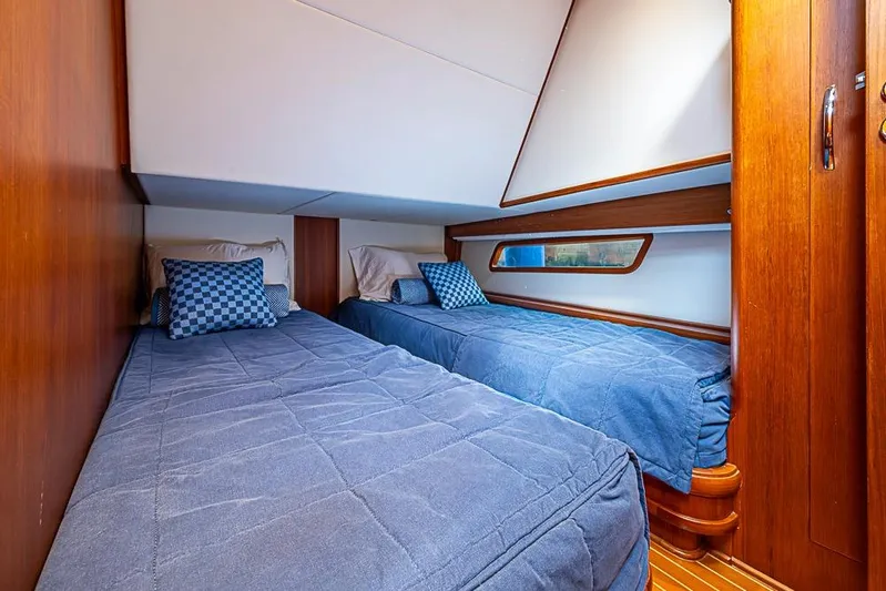 Hayride Yacht Photos Pics Cozy twin cabin in 2013 Grand Banks 43 Europa yacht with blue bedding and wooden accents.