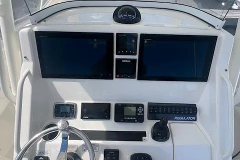  Yacht Photos Pics 2017 Regulator 31 boat dashboard with dual screens and navigation controls.