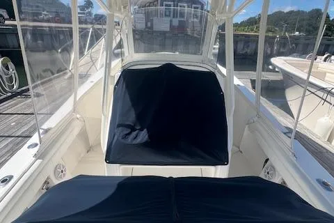  Yacht Photos Pics 2017 Regulator 31 boat interior with covered seating at a marina.