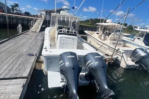  Yacht Photos Pics 2017 Regulator 31 boat docked with dual outboard engines, clear sky background.