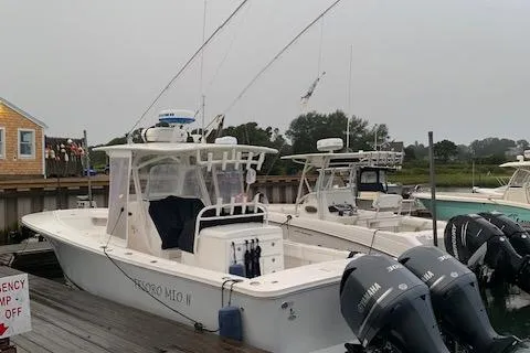  Yacht Photos Pics 2017 Regulator 31 boat docked with twin Yamaha engines, overcast sky.
