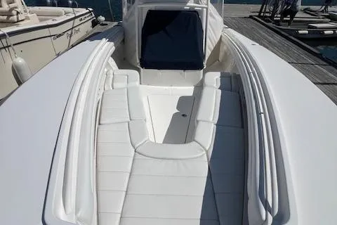  Yacht Photos Pics 2017 Regulator 31 boat with white seating and sleek design at a dock.