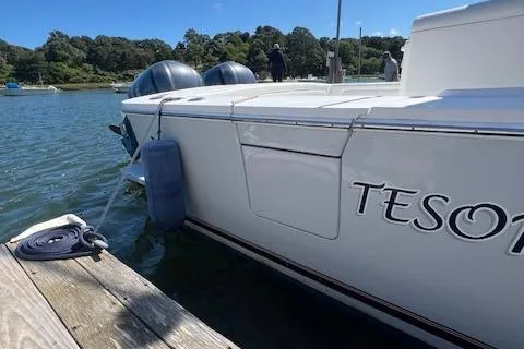  Yacht Photos Pics 2017 Regulator 31 boat docked on calm water, featuring dual engines and a visible fender.